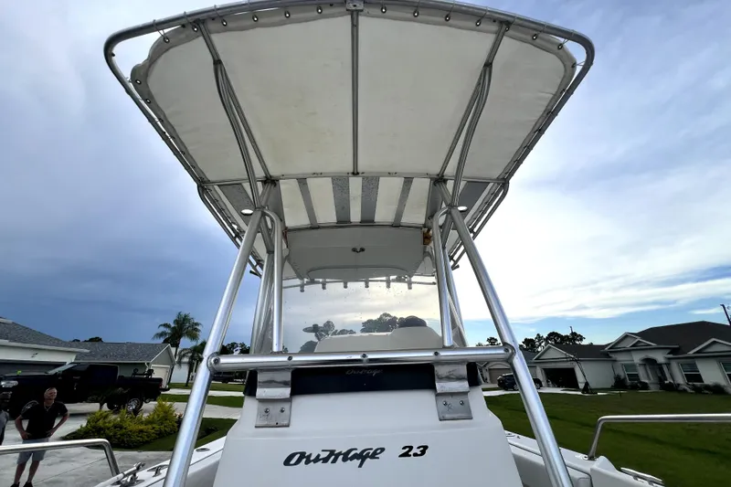 Slide: The Image of 1998 Boston Whaler 230 Outrage boat with T-top, parked in a residential area. - 71