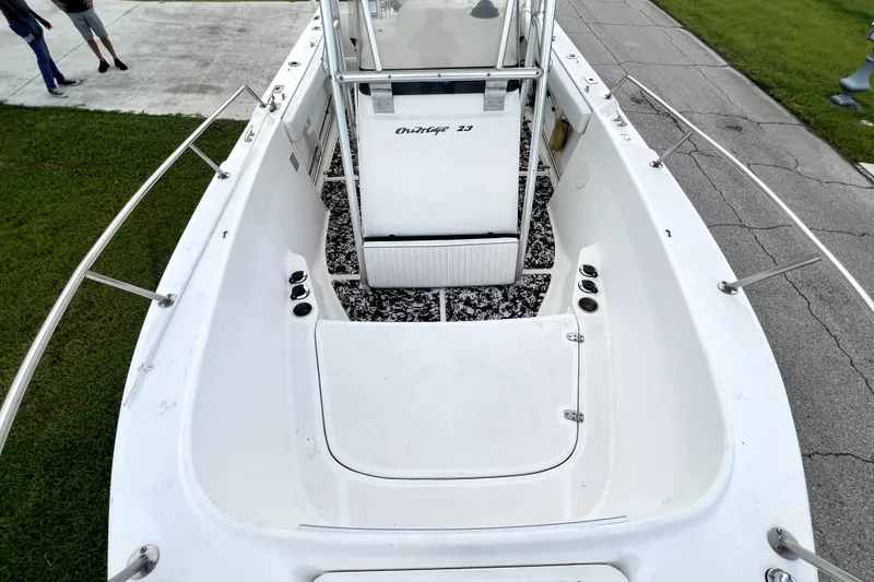 Slide: The Image of 1998 Boston Whaler 230 Outrage boat interior with white deck and railing. - 72