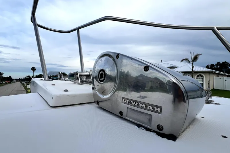 Slide: The Image of 1998 Boston Whaler 230 Outrage boat with Lewmar equipment, docked under cloudy skies. - 73
