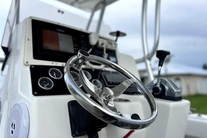 Slide: The Image of Close-up of 1998 Boston Whaler 230 Outrage boat dashboard with steering wheel and controls. - 79