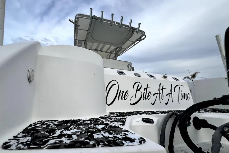 Slide: The Image of 1998 Boston Whaler 230 Outrage boat with "One Bite At A Time" text on the side. - 80
