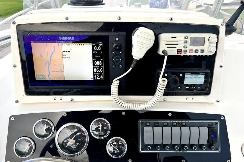 Slide: The Image of Dashboard of a 1998 Boston Whaler 230 Outrage with navigation and communication equipment. - 85