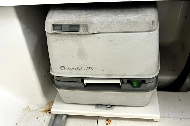 Slide: The Image of Portable toilet on 1998 Boston Whaler 230 Outrage boat, Porta Potti 735 model. - 89