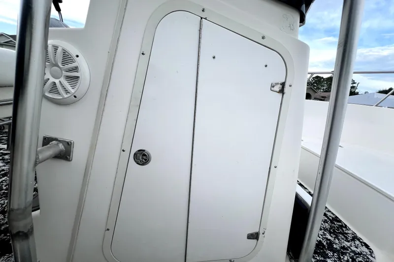 Slide: The Image of 1998 Boston Whaler 230 Outrage boat console with speaker and storage compartment. - 92