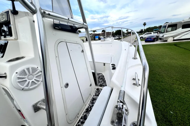 Slide: The Image of 1998 Boston Whaler 230 Outrage boat, featuring sleek design and stainless steel railings. - 94