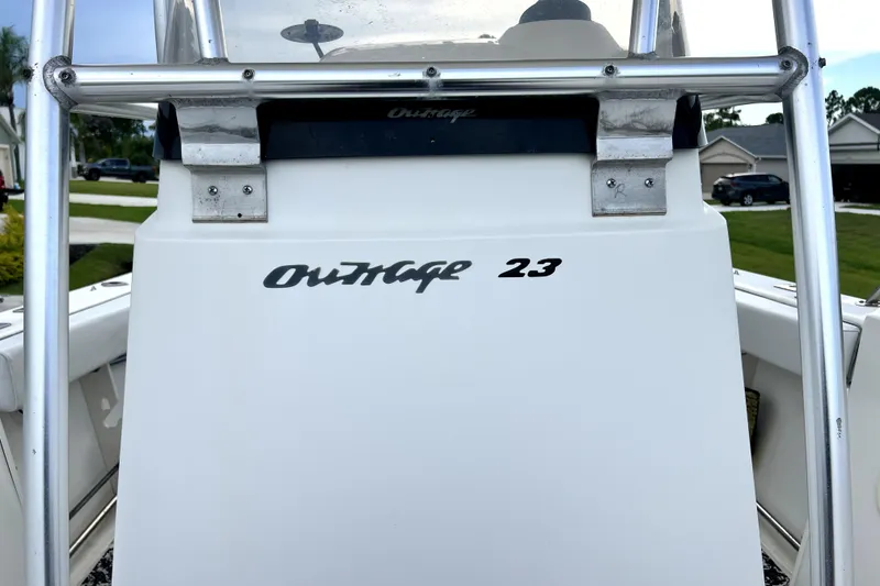 Slide: The Image of 1998 Boston Whaler 230 Outrage boat console with "Outrage 23" branding. - 96
