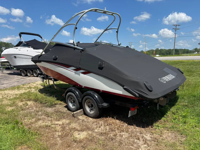 Slide: The Image of A 2014 Yamaha AR210 boat on a trailer, parked on grass. - 8