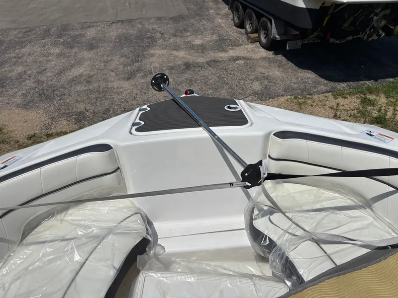Slide: The Image of The image shows the bow of a 2014 Yamaha AR210 boat with white seating. - 11