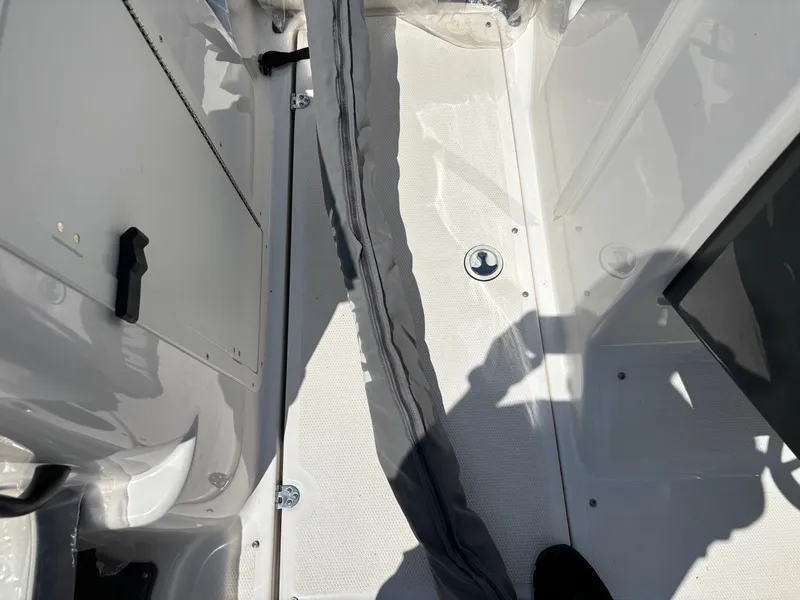 Slide: The Image of Interior of a Yamaha AR210 boat with gray flooring and storage space. - 2