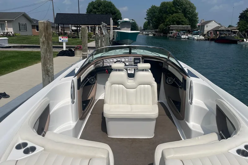 Slide: The Image of 2007 Cobalt 343 boat interior with white seating, docked by a canal. - 6