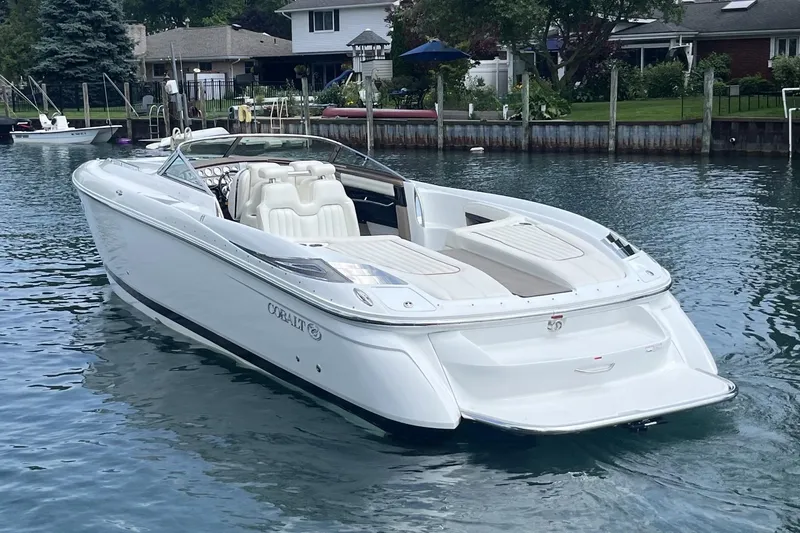 Slide: The Image of 2007 Cobalt 343 boat on calm water near residential docks. - 2