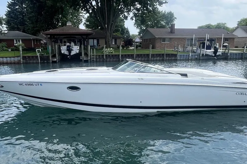 Slide: The Image of 2007 Cobalt 343 boat on water near residential docks. - 1