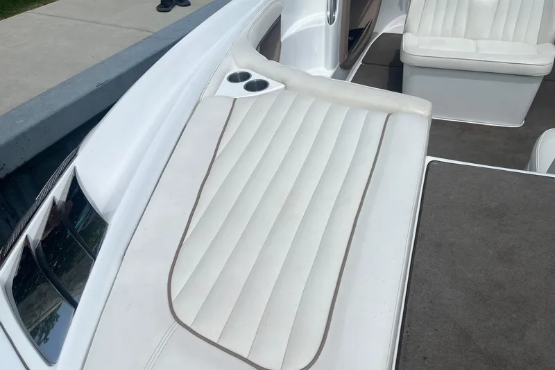 Slide: The Image of 2007 Cobalt 343 boat interior with white cushioned seating and cup holders. - 9