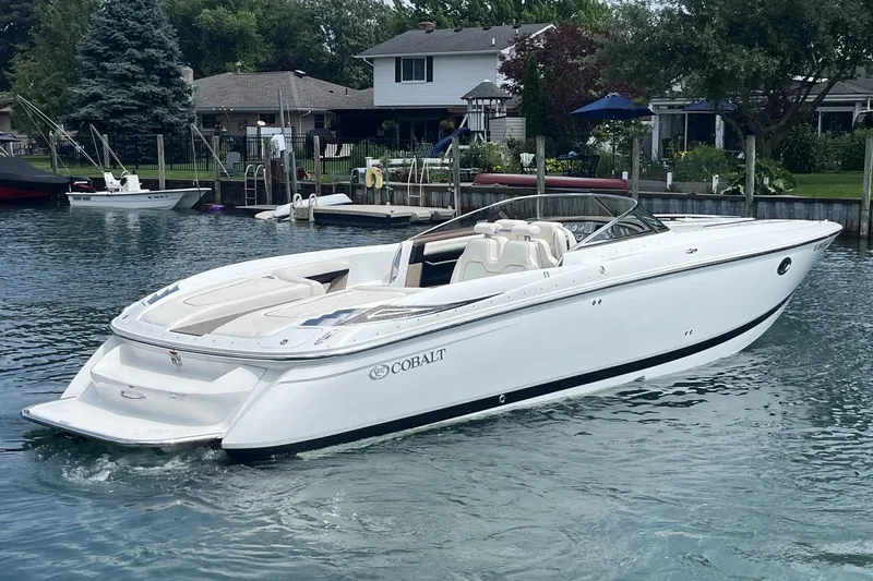 Slide: The Image of 2007 Cobalt 343 boat on a calm lake near waterfront homes. - 3