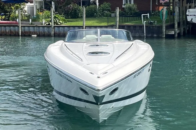 Slide: The Image of Front view of a 2007 Cobalt 343 boat on calm water near a dock. - 4