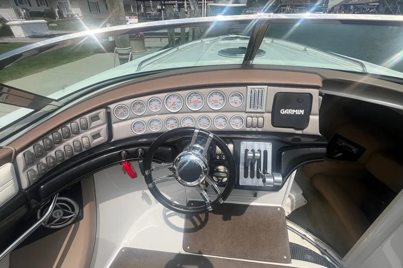 Slide: The Image of Cockpit of a 2007 Cobalt 343 boat with gauges and Garmin navigation system. - 11