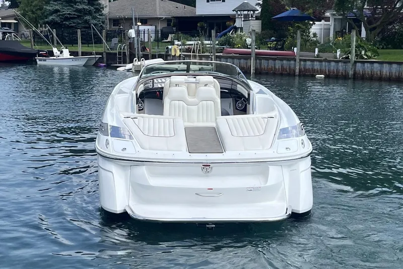 Slide: The Image of 2007 Cobalt 343 boat docked in a serene waterfront setting. - 5