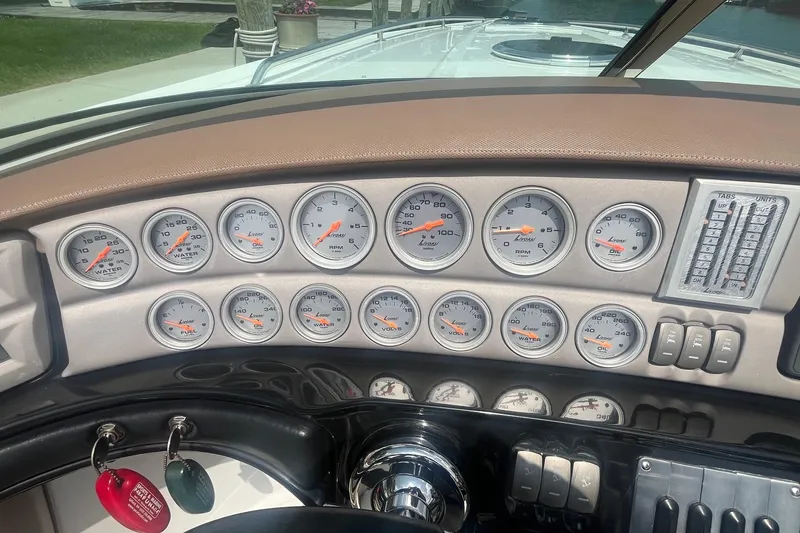 Slide: The Image of Dashboard of a 2007 Cobalt 343 boat with multiple gauges and controls. - 15