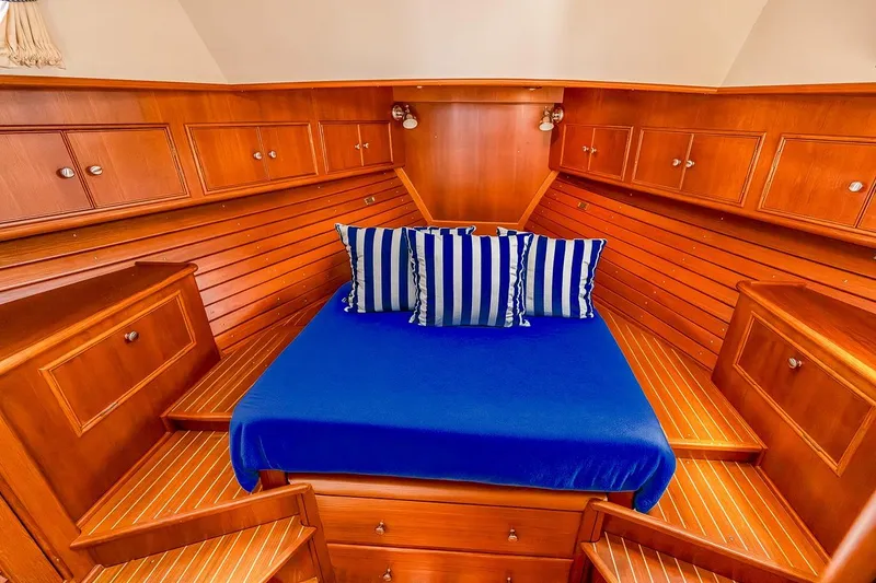 Slide: The Image of Owners centerline queen berth forward; all teak lockers and paneling. - 18