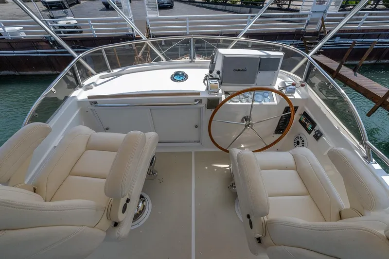 Slide: The Image of Flybridge helm; helm and companion seating; electronics and storage under helm - 24