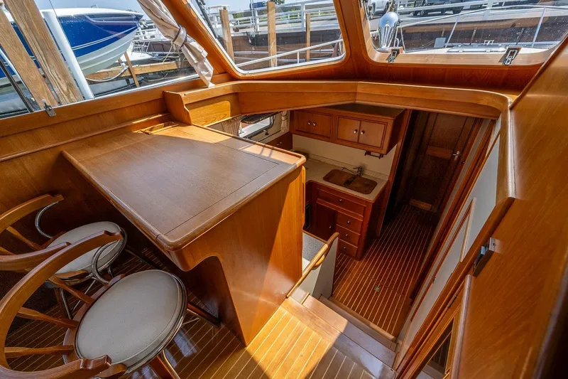 Slide: The Image of Breakfast bar to port; two rattan swivel chairs. Galley down - 10