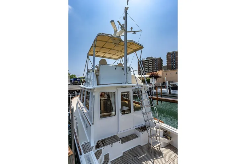 Slide: The Image of 2004 Grand Banks 43 Eastbay FB yacht with flybridge, docked in a marina. - 30