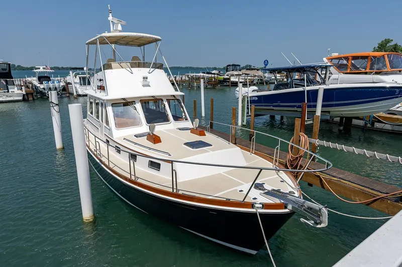 Slide: The Image of 2004 Grand Banks 43 Eastbay FB yacht docked at marina, clear sky, calm water. - 31