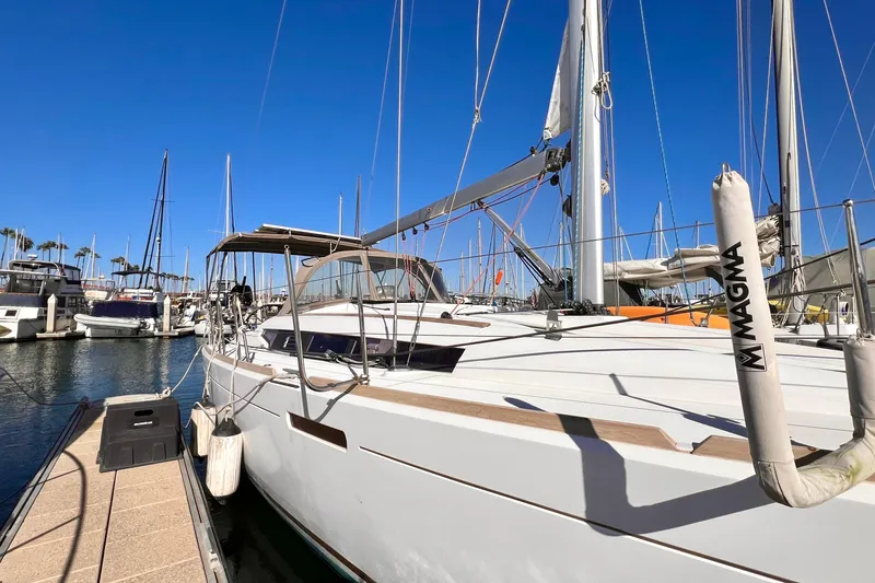 Slide: The Image of 2015 Jeanneau Sun Odyssey 379 sailboat docked at marina under clear blue sky. - 10