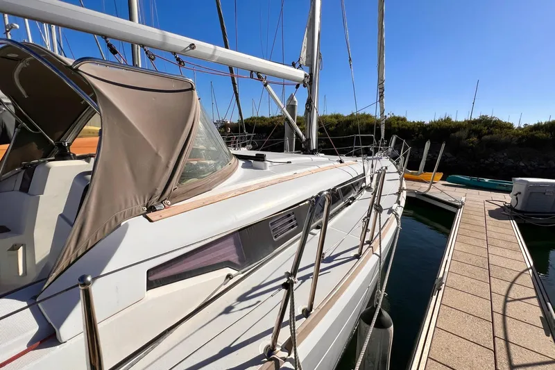 Slide: The Image of 2015 Jeanneau Sun Odyssey 379 sailboat docked at marina under clear blue sky. - 11