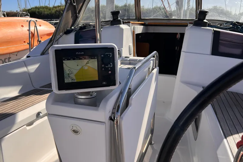 Slide: The Image of Cockpit of 2015 Jeanneau Sun Odyssey 379 with navigation display and steering wheel. - 16