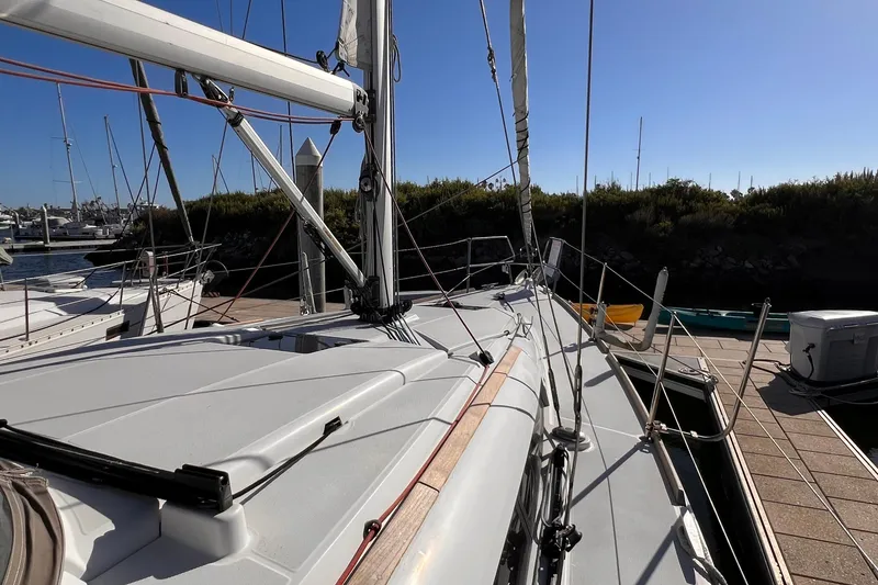Slide: The Image of Jeanneau Sun Odyssey 379 sailboat docked, showcasing deck and rigging, 2015 model. - 19
