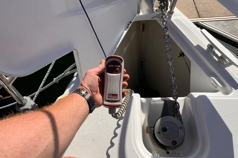 Slide: The Image of Hand holding remote for anchor winch on 2015 Jeanneau Sun Odyssey 379 sailboat. - 21
