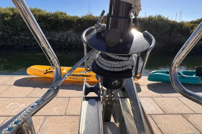 Slide: The Image of Bow of 2015 Jeanneau Sun Odyssey 379 with mooring line and kayaks in background. - 22