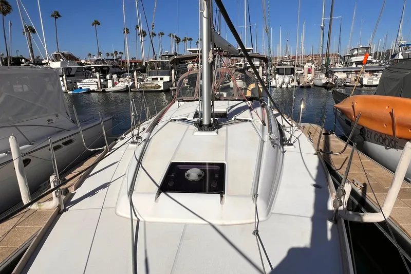 Slide: The Image of Jeanneau Sun Odyssey 379 sailboat docked at marina, surrounded by other boats. - 23