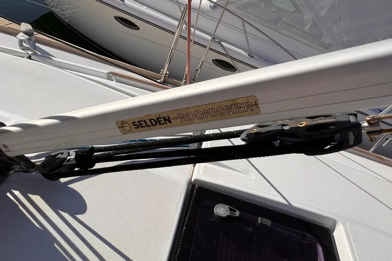 Slide: The Image of Close-up of a sailboat with Selden Rodkicker branding on the boom. - 24