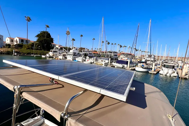 Slide: The Image of Jeanneau Sun Odyssey 379 (2015) with solar panel in a marina, surrounded by sailboats. - 26