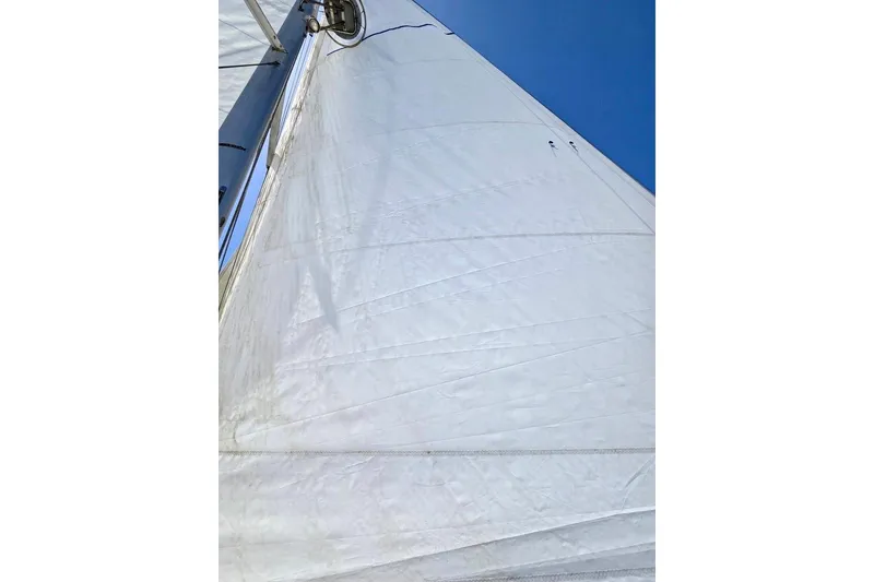 Slide: The Image of Sail of a 2015 Jeanneau Sun Odyssey 379 against a clear blue sky. - 27