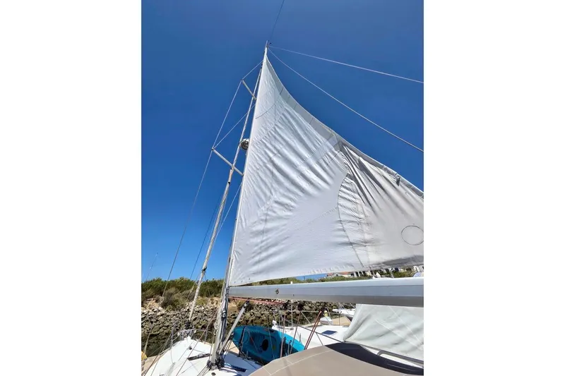 Slide: The Image of Sail of 2015 Jeanneau Sun Odyssey 379 against clear blue sky. - 28