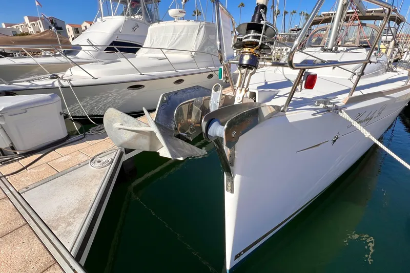 Slide: The Image of 2015 Jeanneau Sun Odyssey 379 yacht docked at marina, showcasing anchor and sleek design. - 3