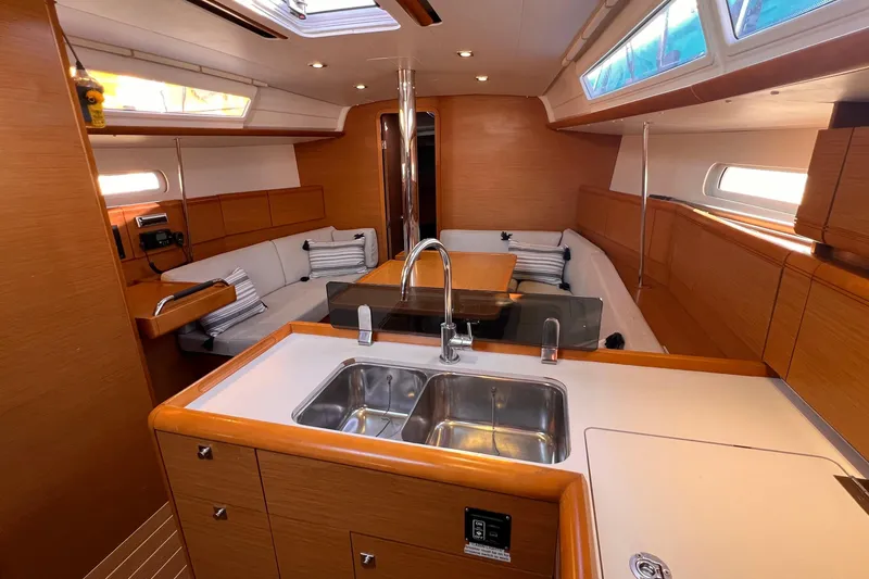 Slide: The Image of Interior of 2015 Jeanneau Sun Odyssey 379 sailboat with modern kitchen and seating area. - 32