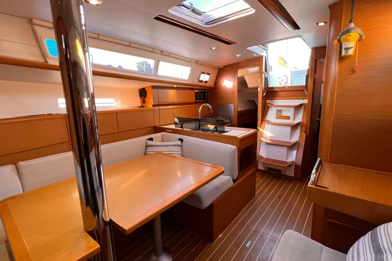 Slide: The Image of Interior of 2015 Jeanneau Sun Odyssey 379 sailboat with modern wood finish and cozy seating. - 36