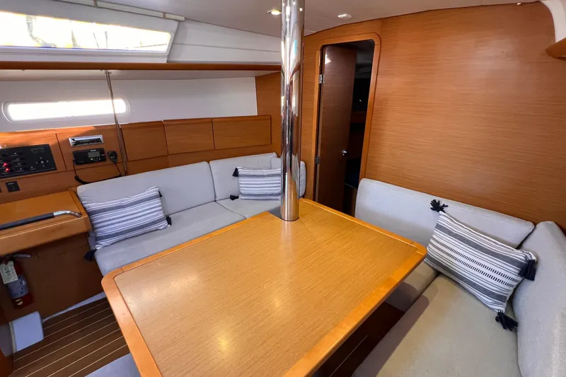 Slide: The Image of Interior of 2015 Jeanneau Sun Odyssey 379 sailboat with cozy seating and wooden table. - 37