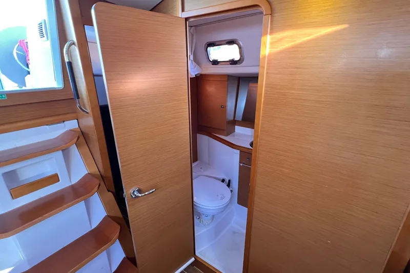 Slide: The Image of Interior of 2015 Jeanneau Sun Odyssey 379 yacht showing bathroom and wooden stairs. - 38