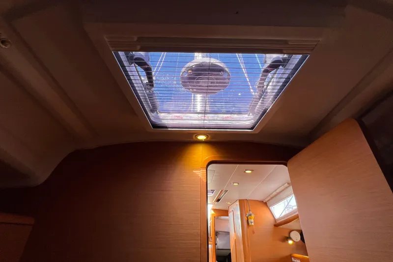 Slide: The Image of Interior view of 2015 Jeanneau Sun Odyssey 379 sailboat with skylight and wooden finish. - 44