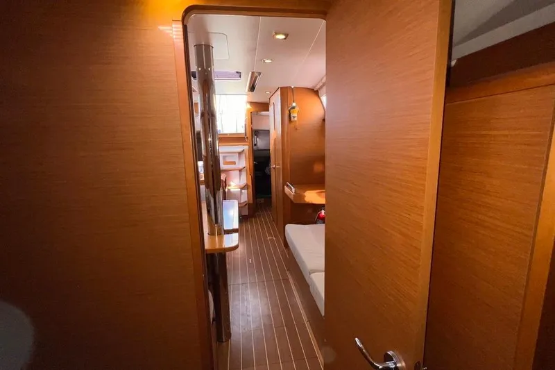Slide: The Image of Interior view of 2015 Jeanneau Sun Odyssey 379 sailboat, featuring wooden finishes and cozy layout. - 45