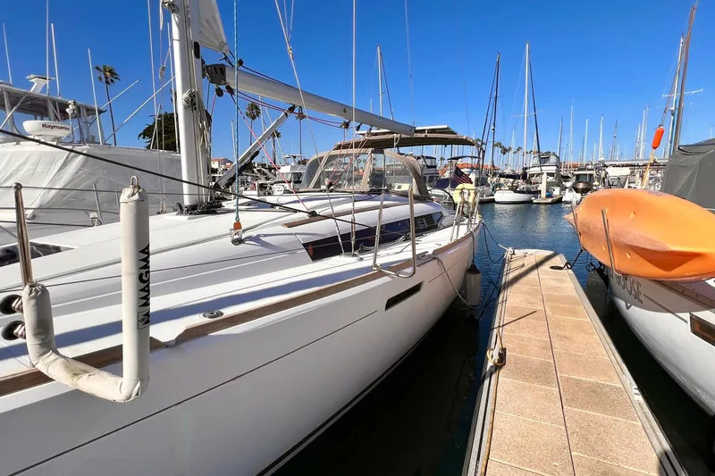Slide: The Image of 2015 Jeanneau Sun Odyssey 379 sailboat docked in a marina under clear blue skies. - 5