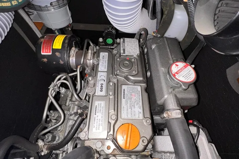 Slide: The Image of Engine compartment of a 2015 Jeanneau Sun Odyssey 379 sailboat, featuring detailed mechanical components. - 53