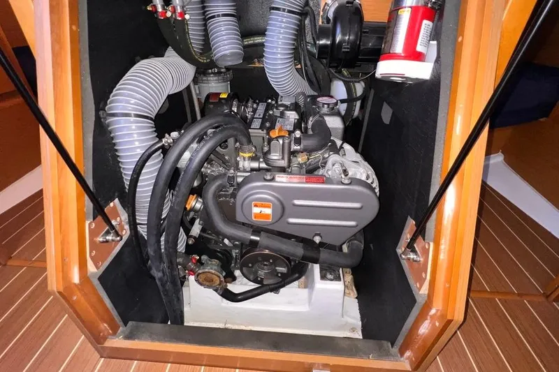 Slide: The Image of Engine compartment of 2015 Jeanneau Sun Odyssey 379 sailboat, showcasing mechanical components. - 54