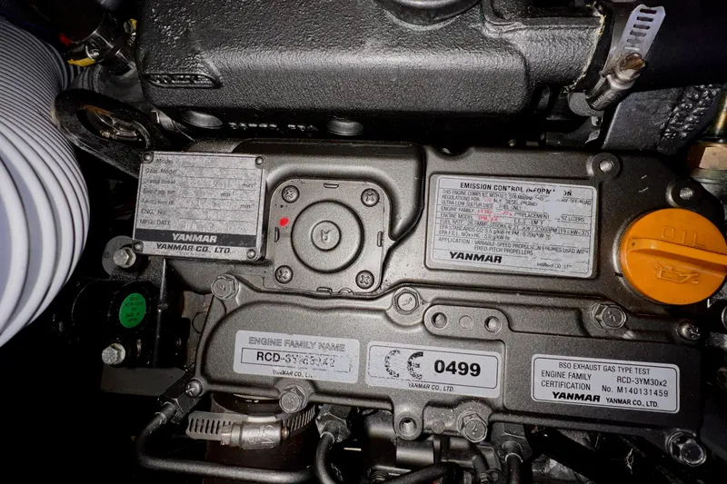 Slide: The Image of Engine compartment of a 2015 Jeanneau Sun Odyssey 379 sailboat, featuring Yanmar components. - 56