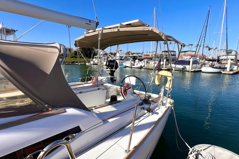 Slide: The Image of 2015 Jeanneau Sun Odyssey 379 sailboat docked in a marina under clear blue skies. - 7